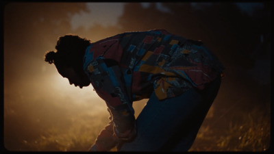 a man kneeling down in a field of grass