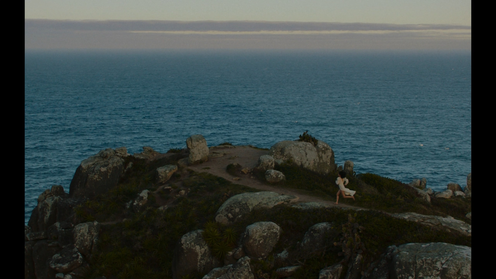 a couple of people sitting on top of a rock formation