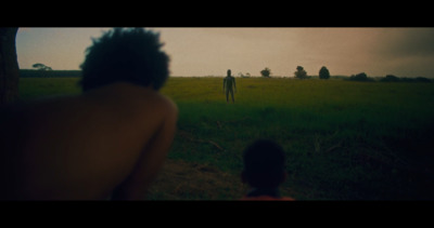 a man and a woman standing in a field