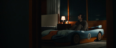 a man sitting on top of a bed in a bedroom