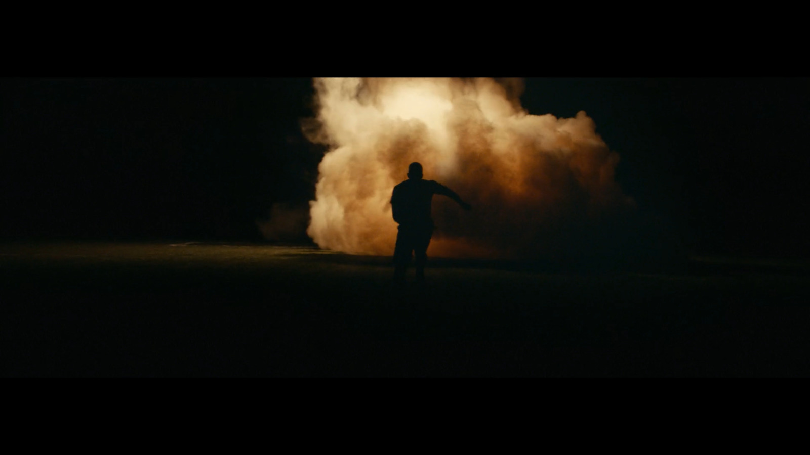 a man standing in front of a cloud of smoke