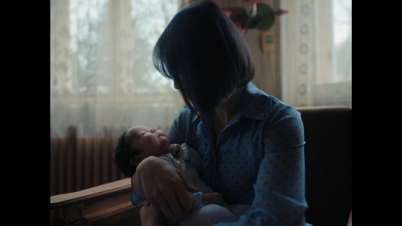 a woman holding a baby in her arms