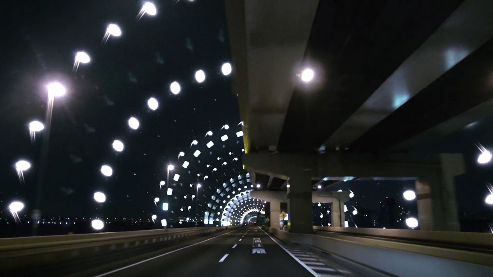 a car driving down a highway at night