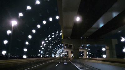 a car driving down a highway at night