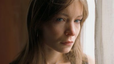 a close up of a person looking out a window