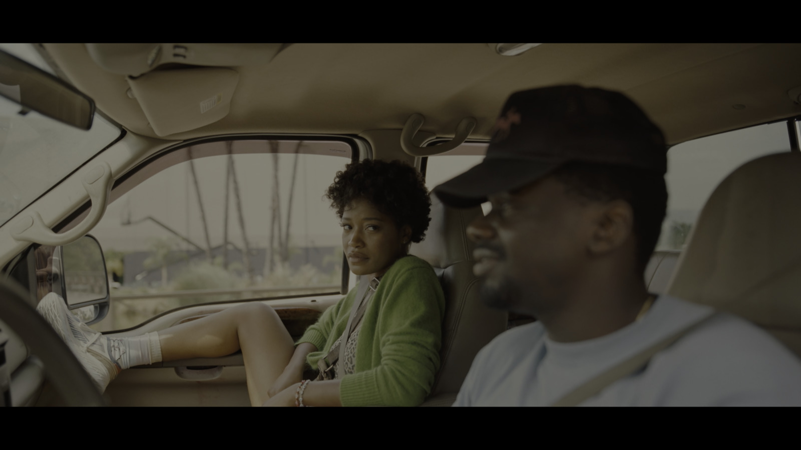 a man and a woman sitting in a car