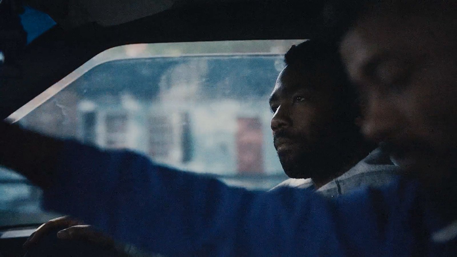 a man driving a car in the rain