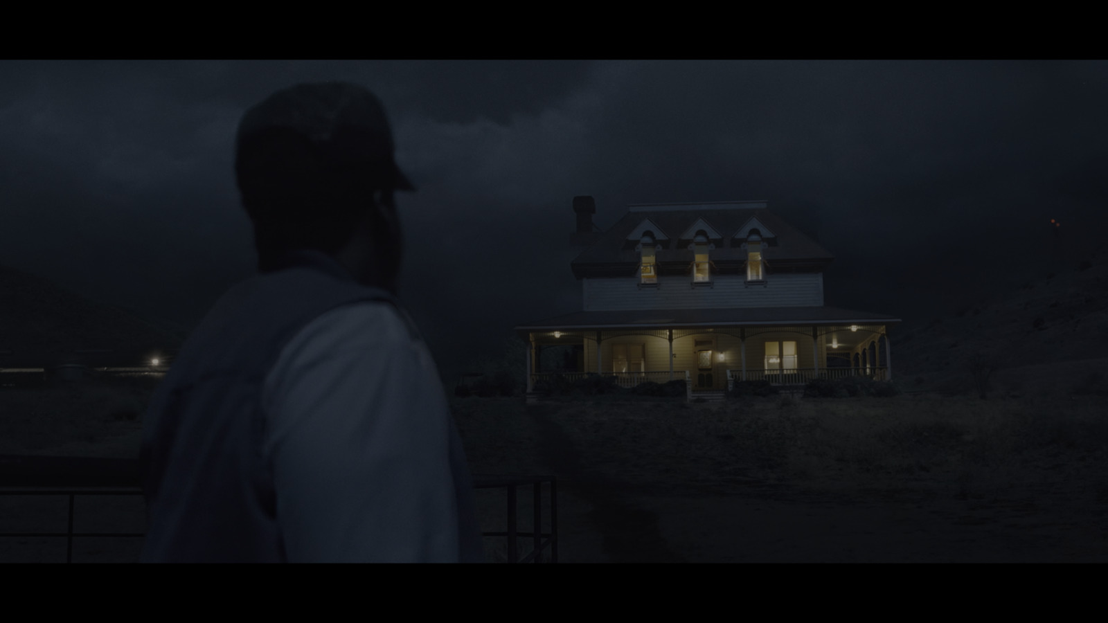 a man standing in front of a house at night