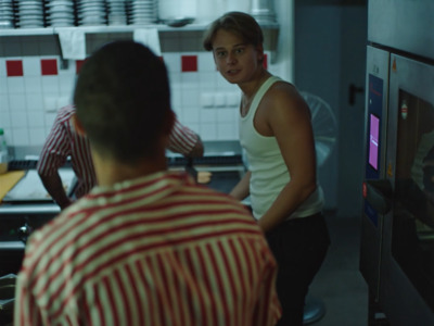 a man standing next to a woman in a kitchen