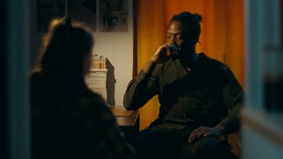 a man sitting in a chair talking on a cell phone