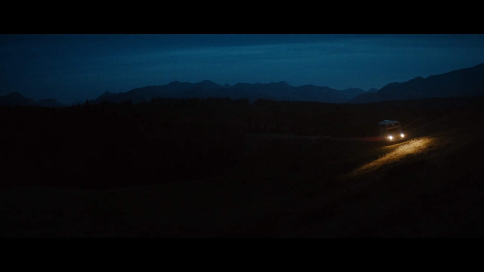 a car driving down a road at night