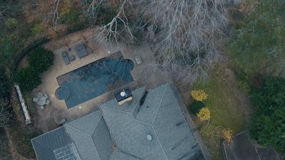 an aerial view of a house with a swimming pool