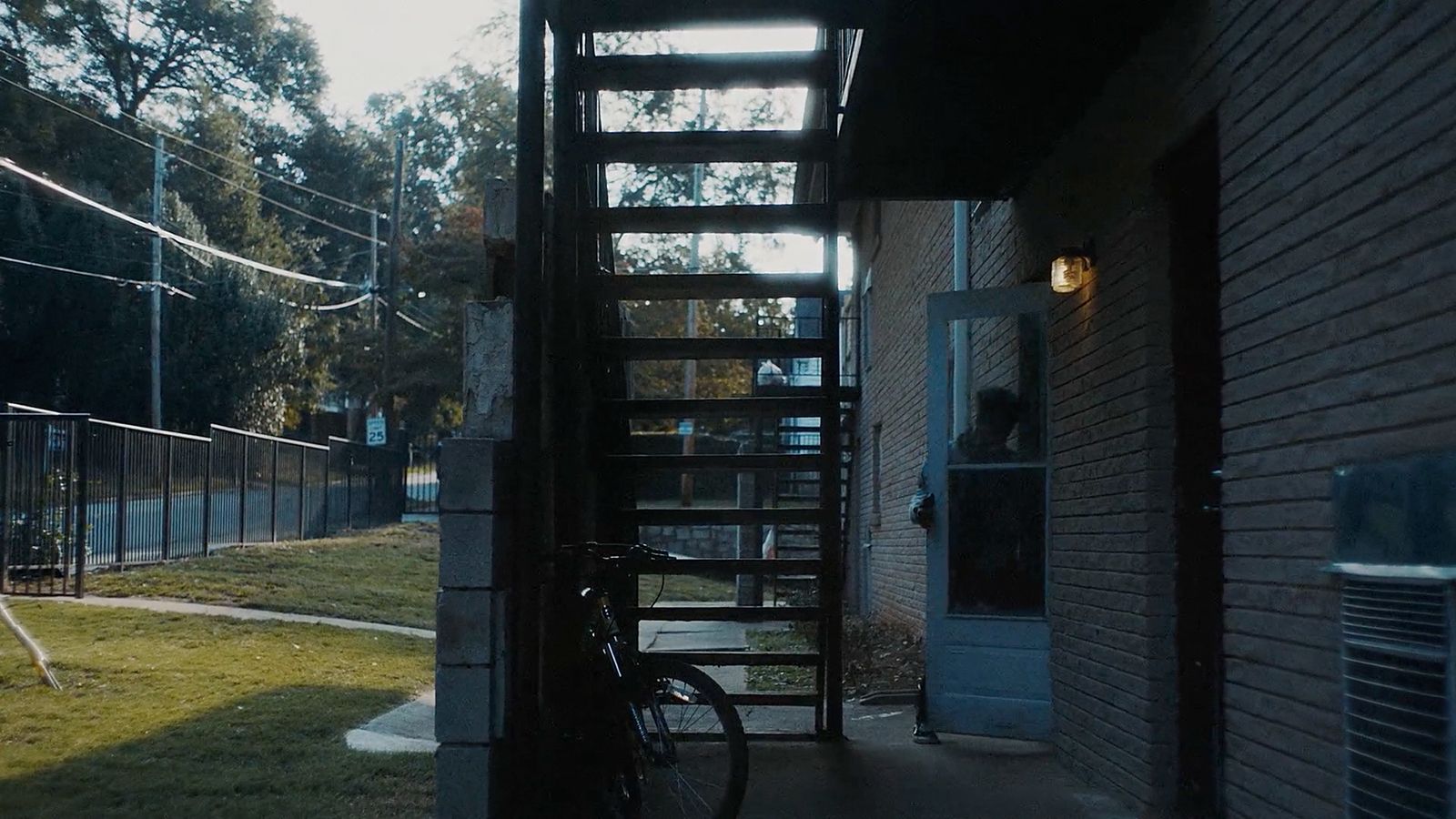 a bicycle parked in front of a brick building