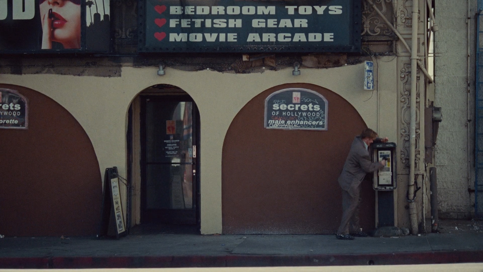 a man standing in front of a movie theater