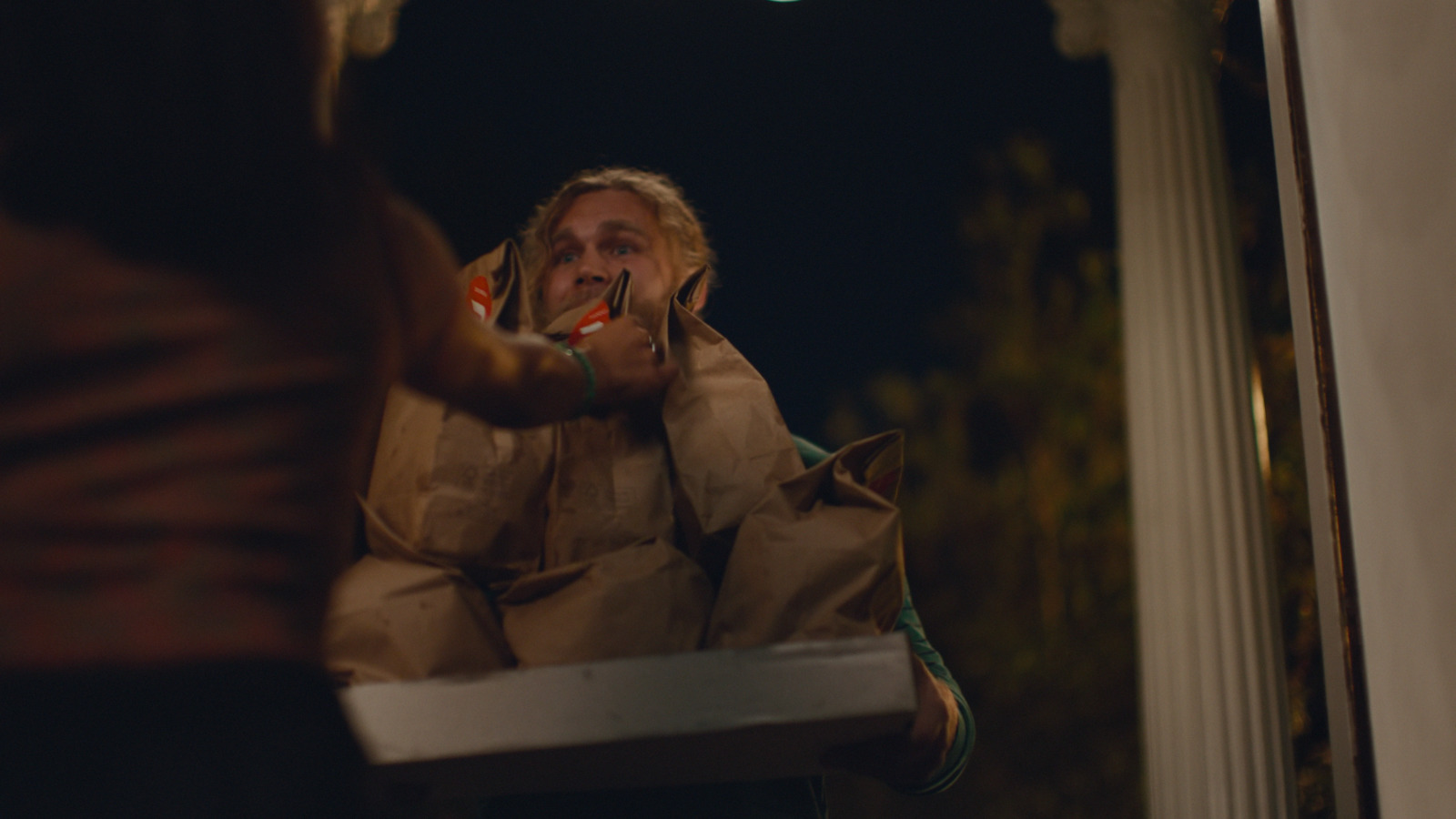 a man in a brown jacket brushing his teeth