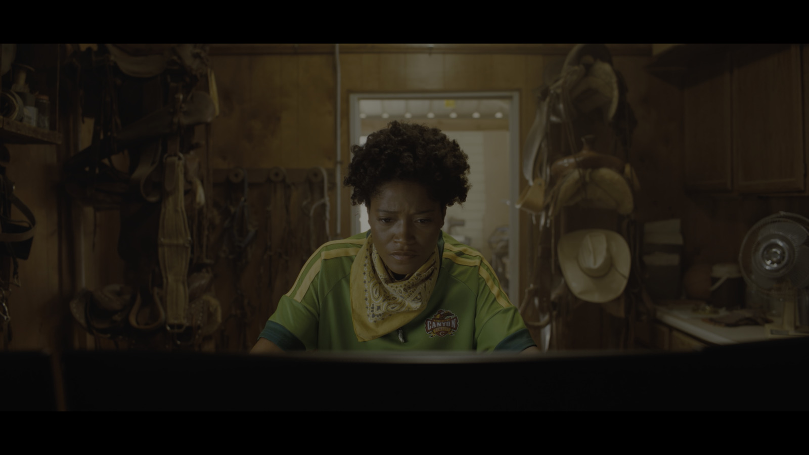 a woman sitting at a table in a kitchen