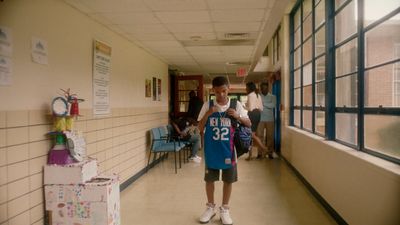 a young man is standing in a hallway