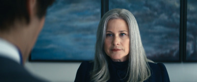 a woman with grey hair looking at a man