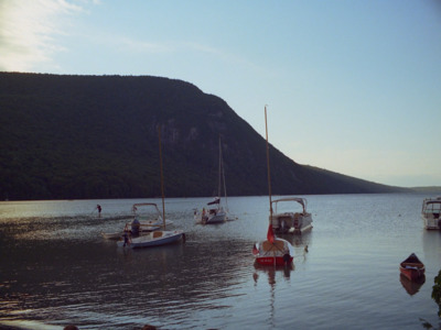 a group of boats floating on top of a lake