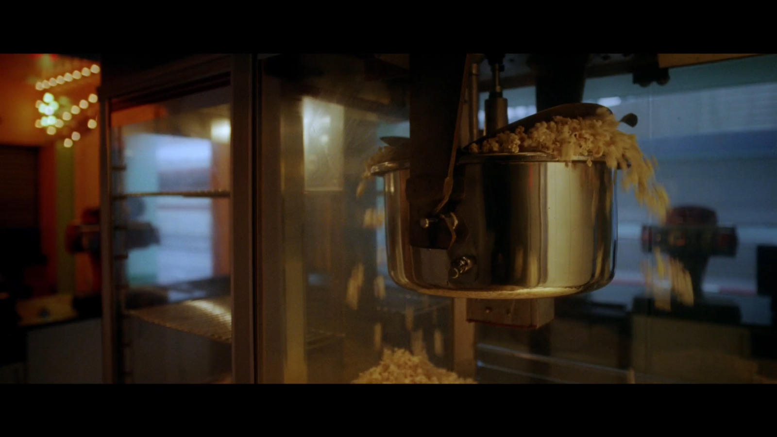 a large pot of popcorn hanging from a wall