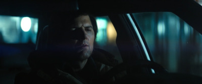 a man sitting in a car in the dark