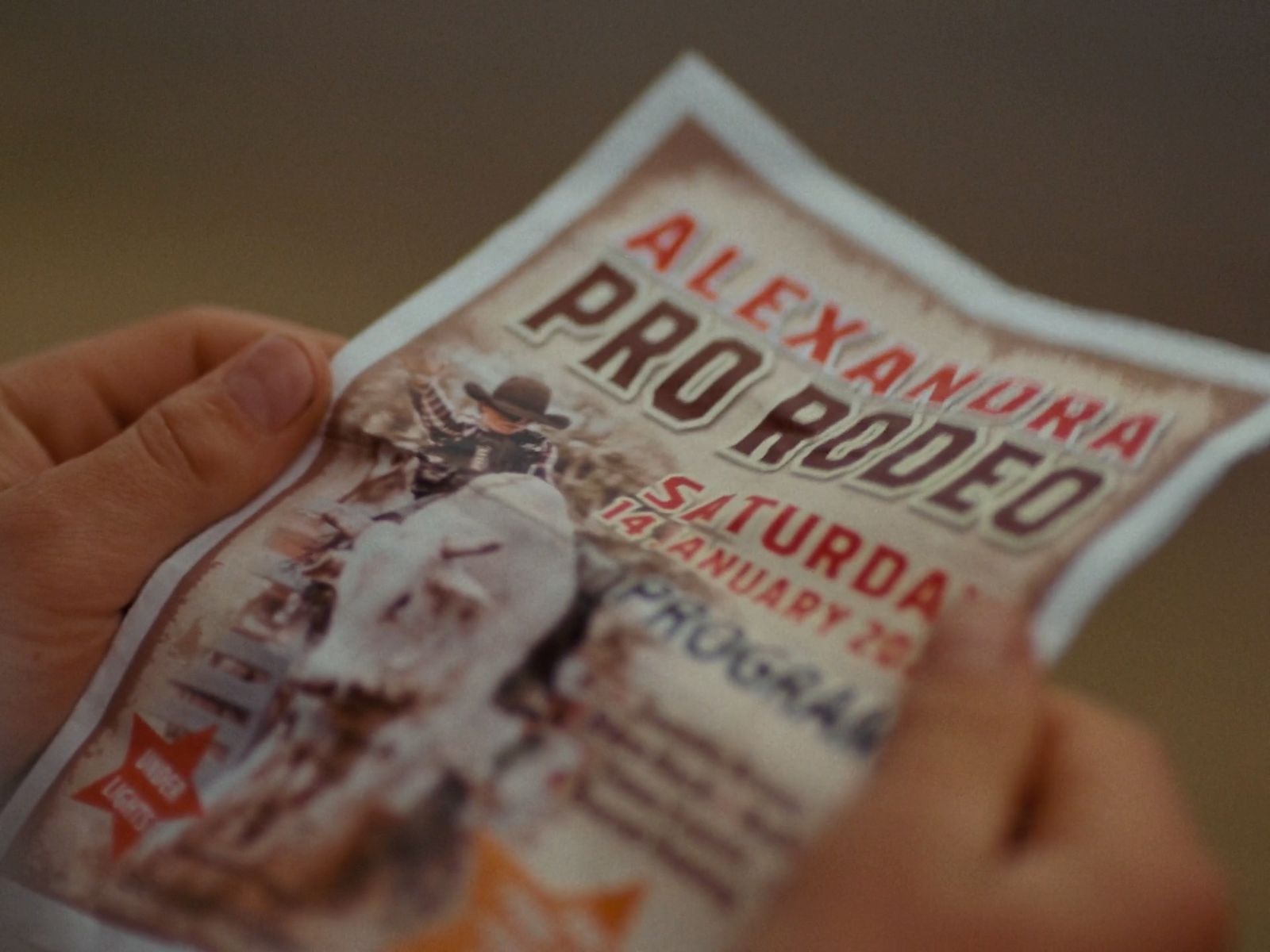 a person holding up a ticket for a baseball game