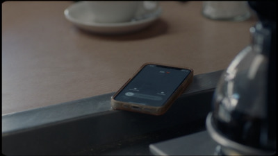 a cell phone sitting on top of a wooden table