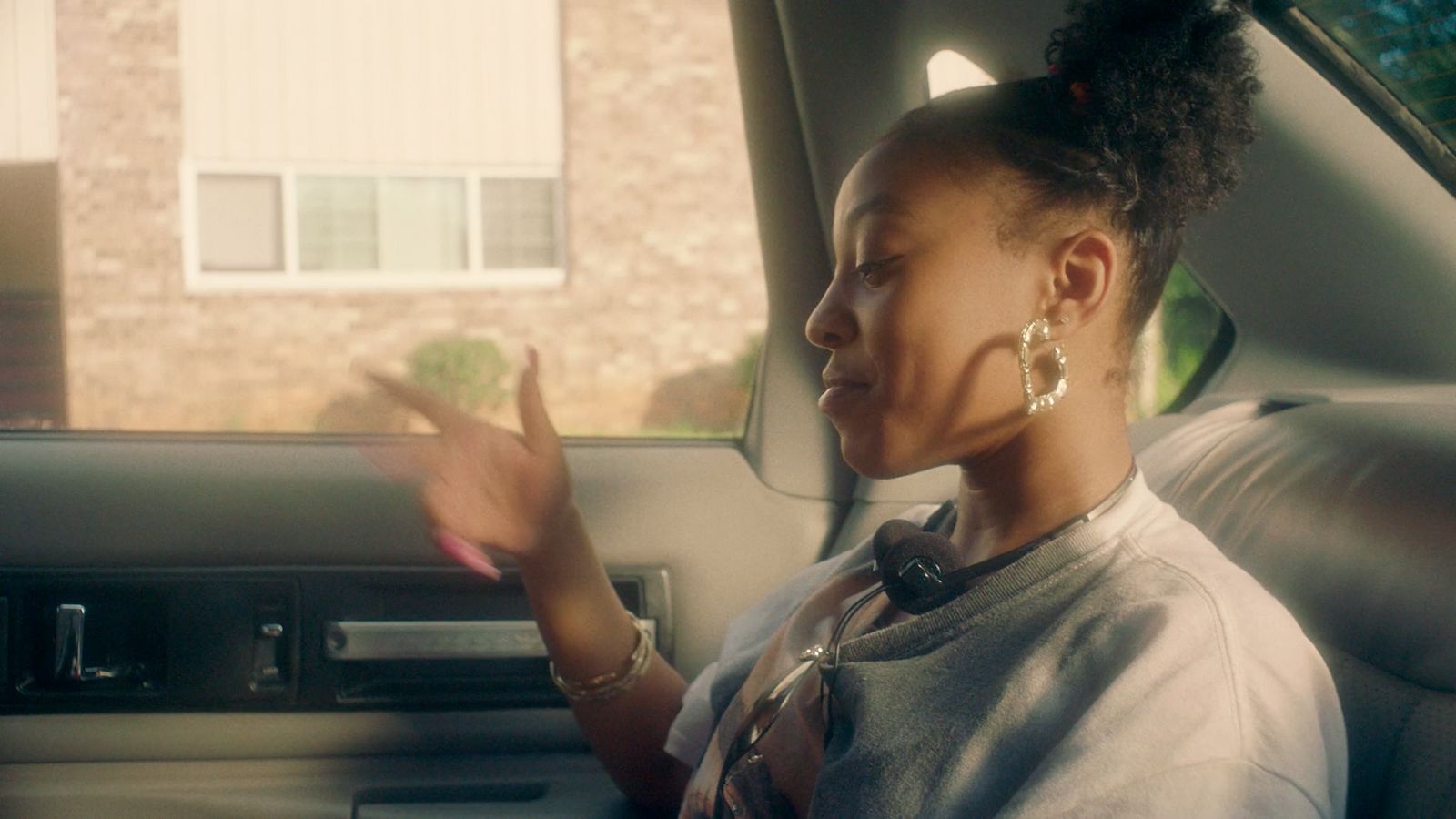 a woman sitting in the back seat of a car