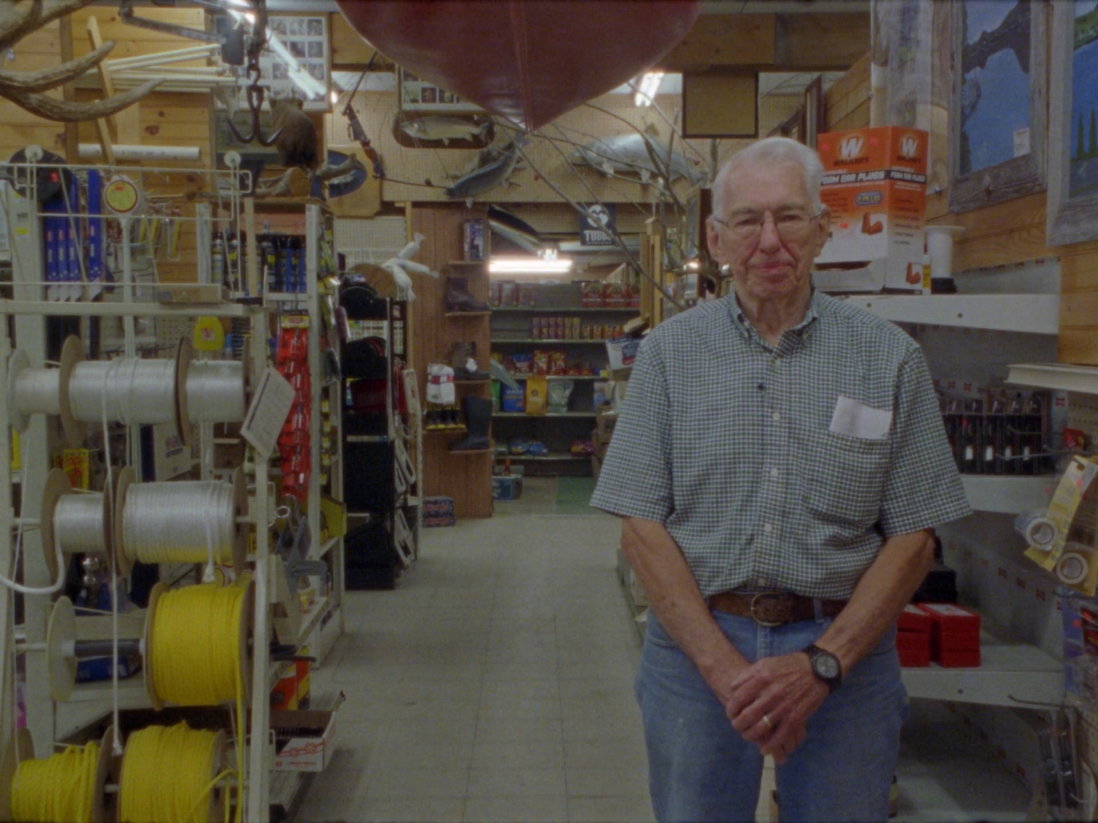 a man standing in a store with a large balloon in the background