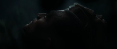 a close up of a person's face in the dark