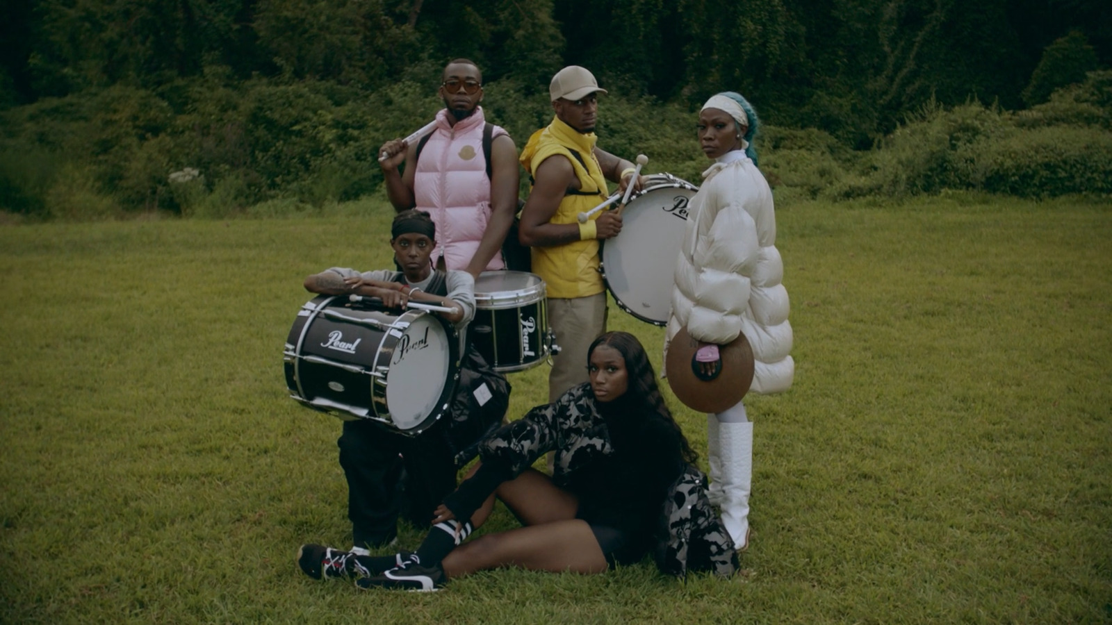 a group of people that are standing in the grass