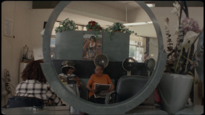 a woman sitting in a chair in front of a mirror