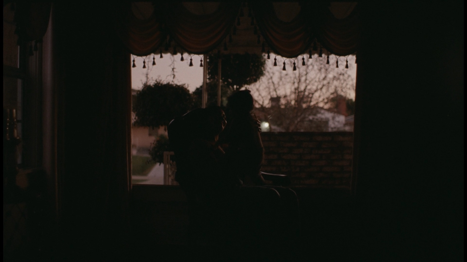 a couple of people sitting in a dark room