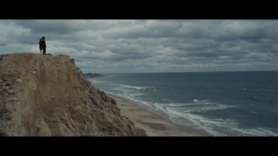 a person standing on a cliff overlooking the ocean