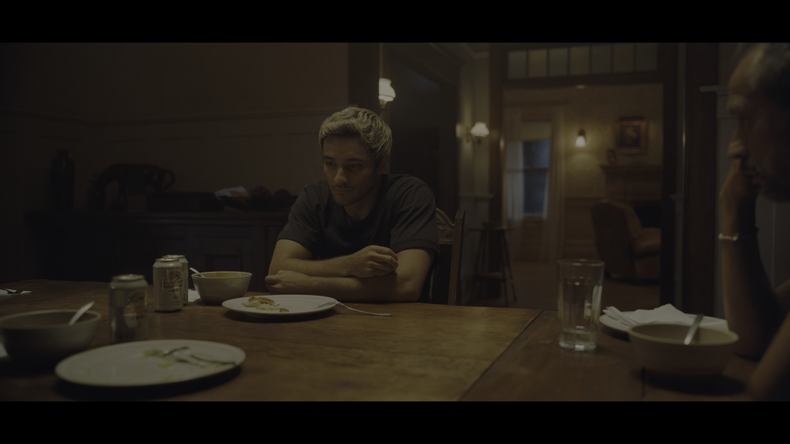 a man sitting at a table with a plate of food