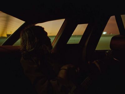 a person sitting in a car at night