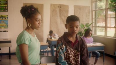 a couple of women standing next to each other in a classroom