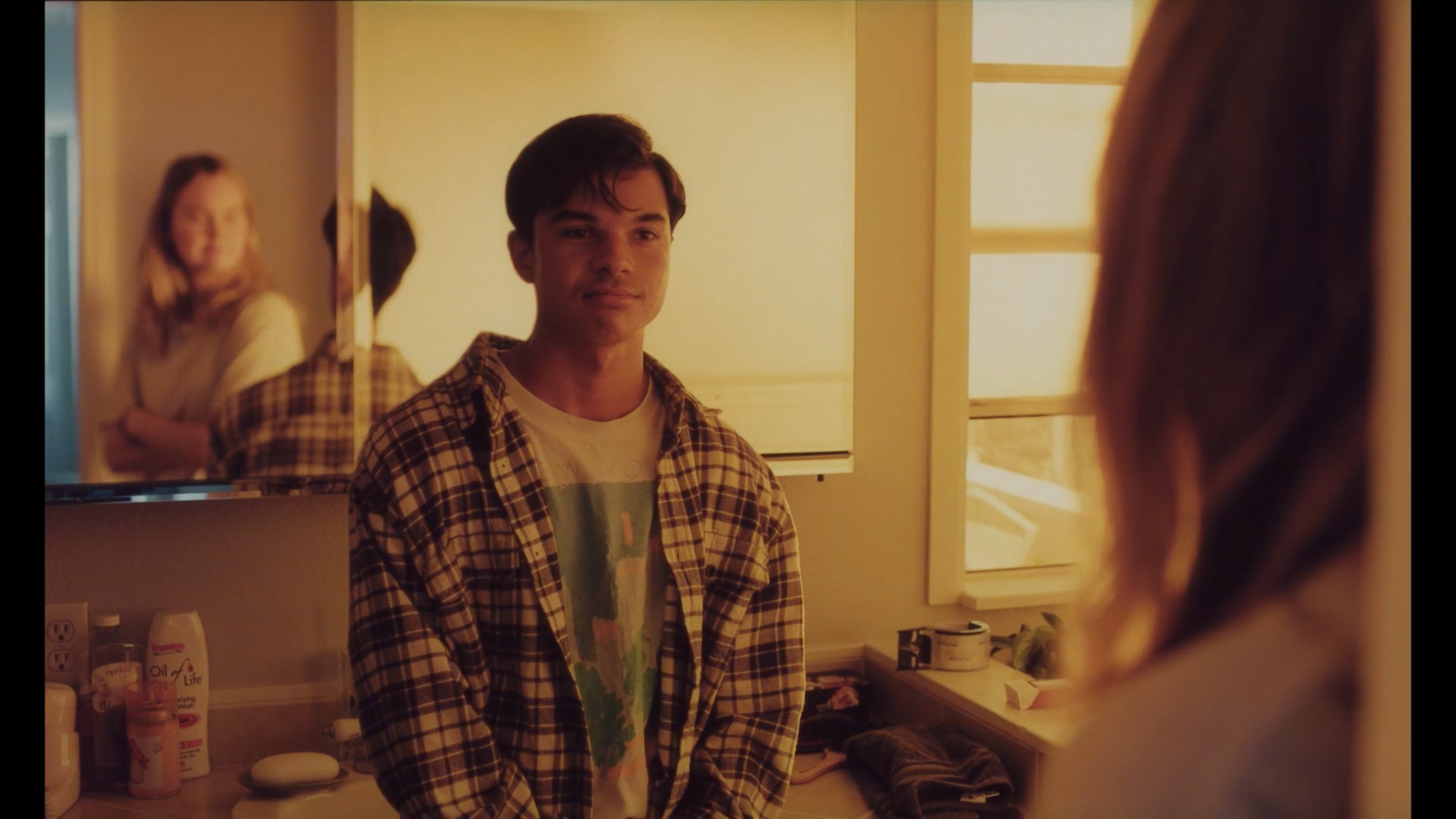 a man standing in front of a mirror in a bathroom