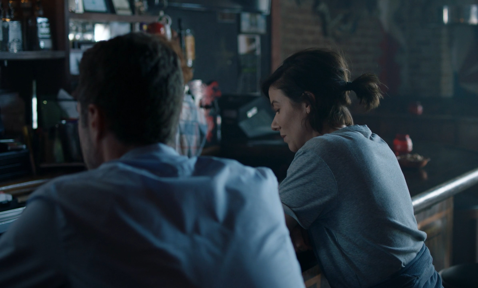 a man and a woman sitting at a bar