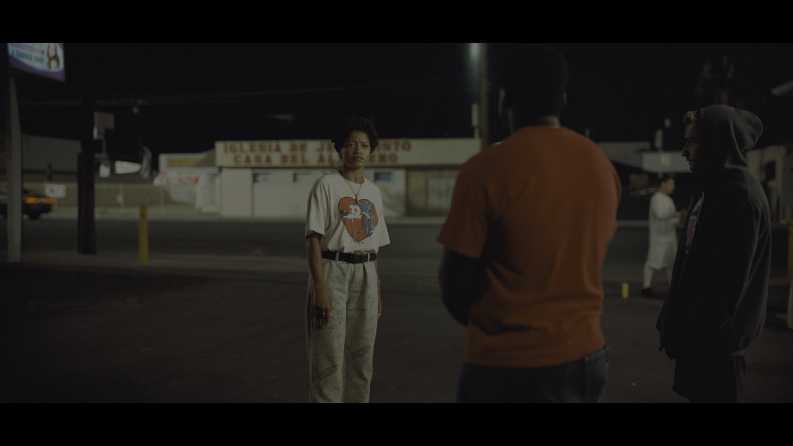 a group of people standing around a parking lot