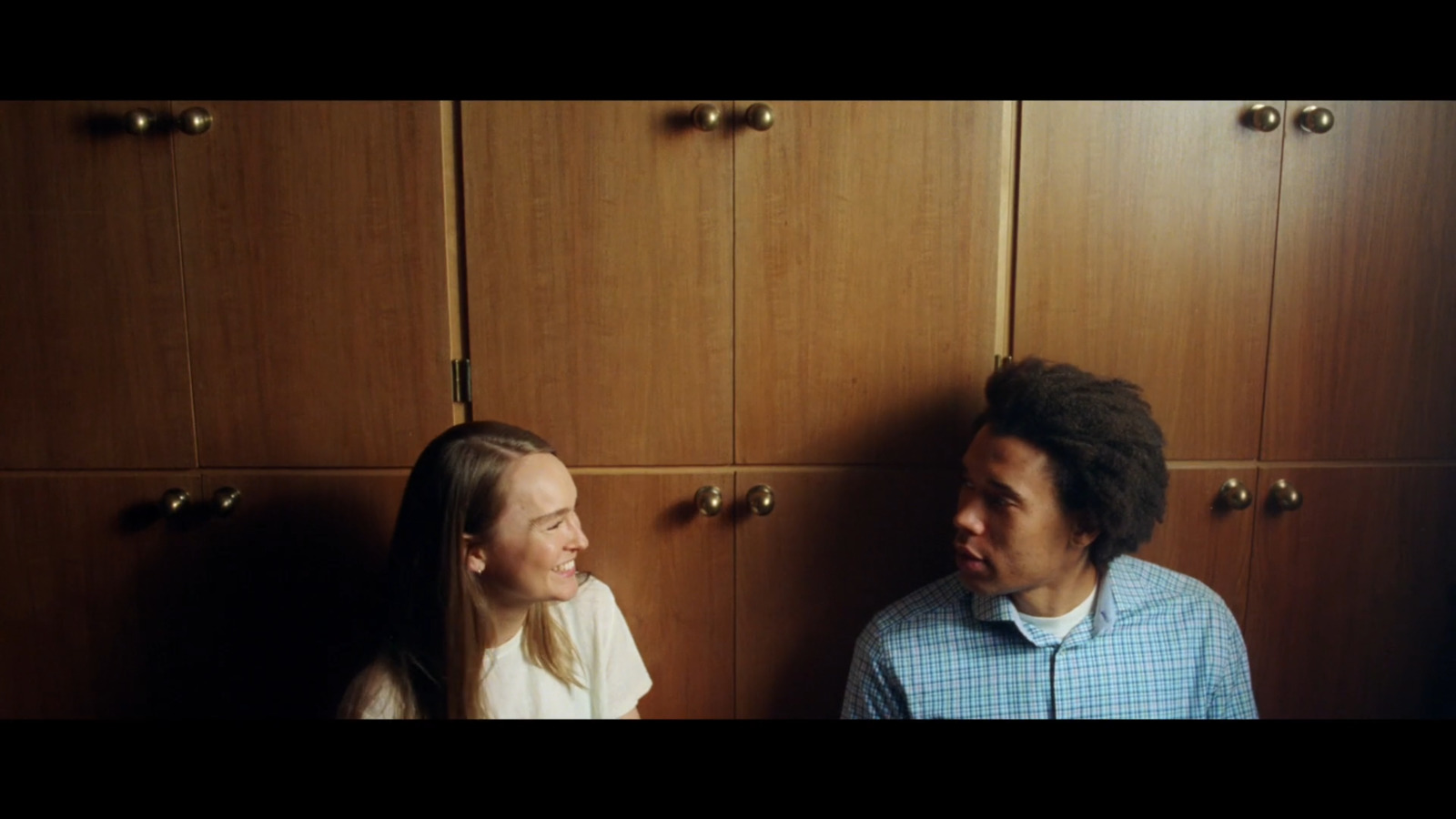 a man standing next to a woman in a kitchen