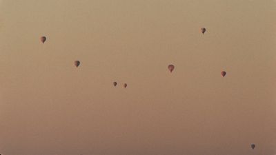 a group of hot air balloons flying in the sky