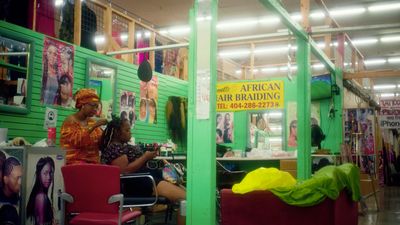 a woman sitting in a chair in a hair salon
