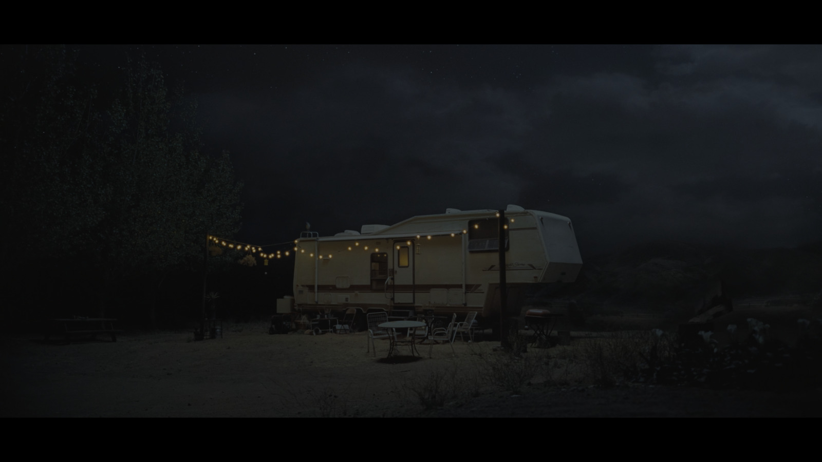 a trailer parked in a field at night