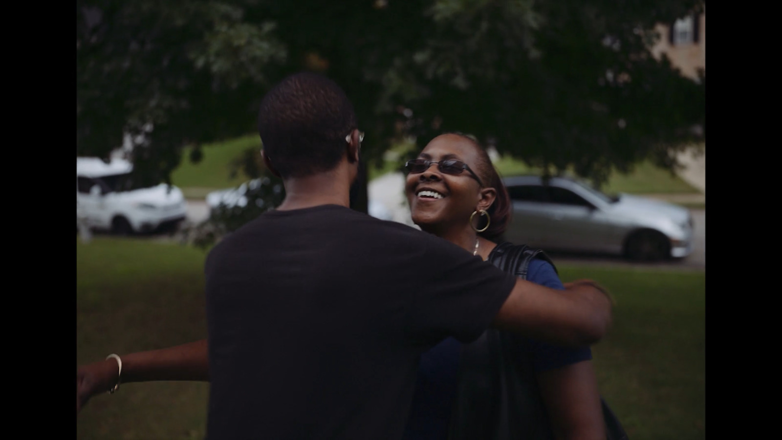 a man standing next to a woman in a park