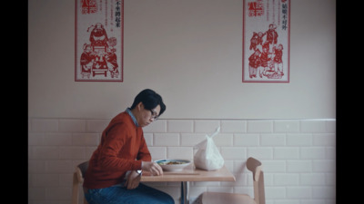 a man sitting at a table with a plate of food in front of him