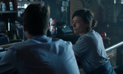 a man and a woman sitting at a bar