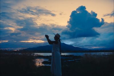 a person standing in front of a body of water