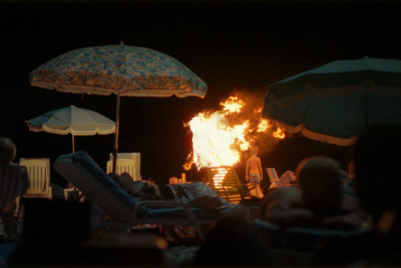 a group of people sitting around a fire pit