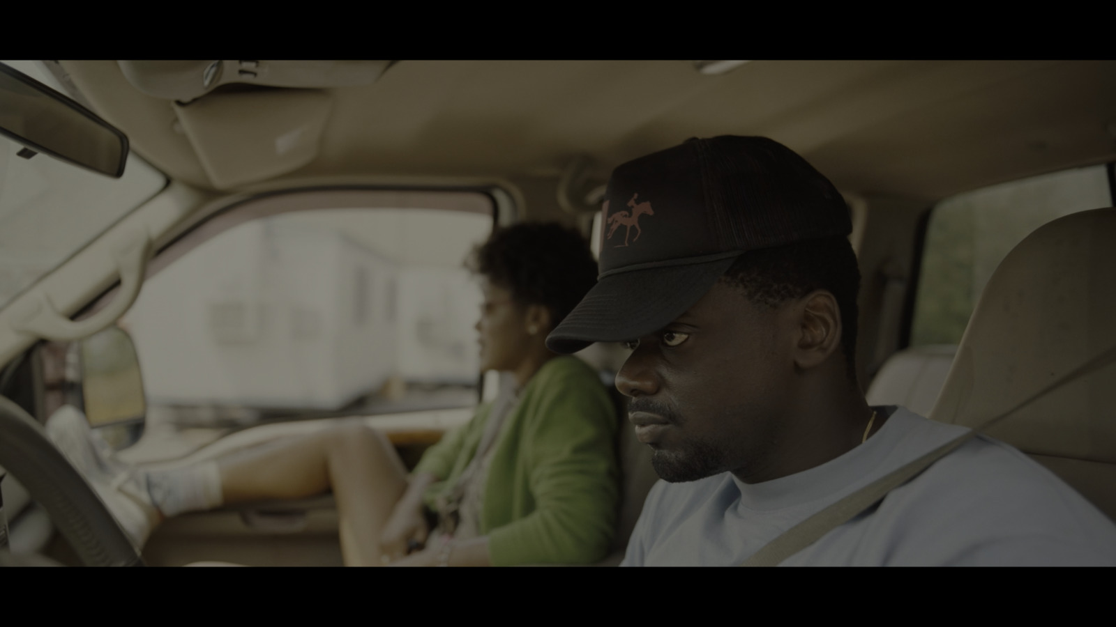 a man and a woman sitting in a car